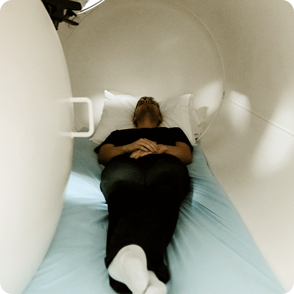 Male patient laying down and relaxing in the Hyperbaric Chamber tube