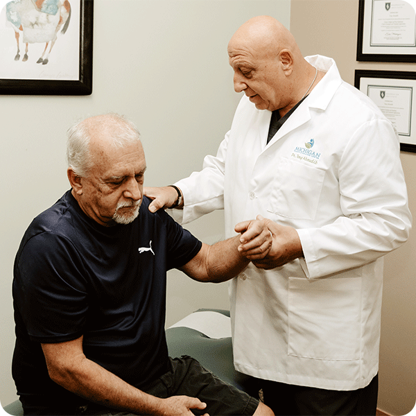 Doctor Tony checks on the pain and range of motion of male patient's left arm