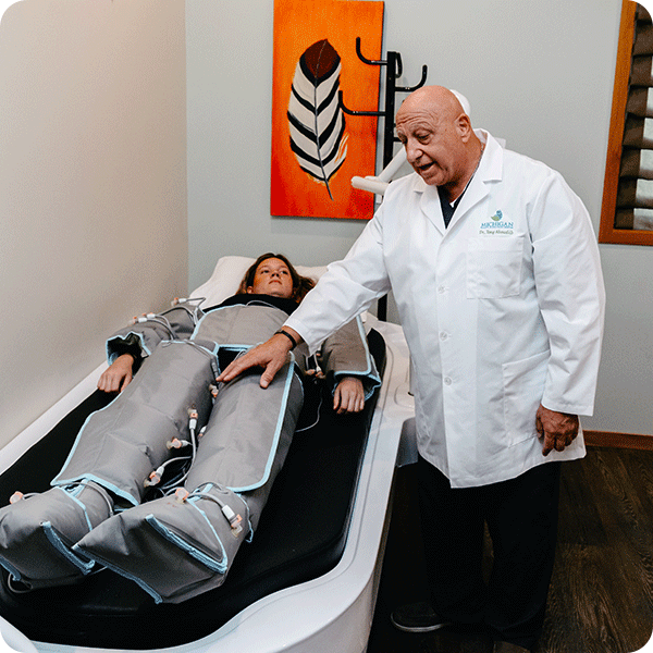 Doctor Tony checks on female patient using pressotherapy