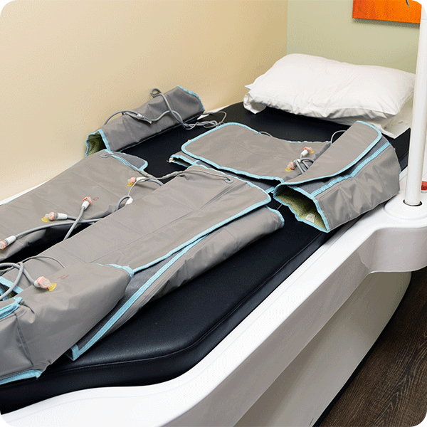 Empty pressontherapy equipment lays on patient bed