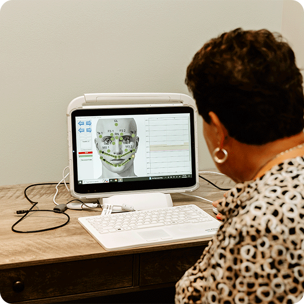 Shirley reviews brain scan data on computer screen