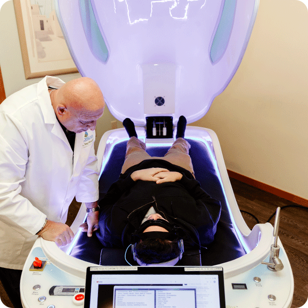 Doctor Tony prepares male patient for Theta Chamber treatment