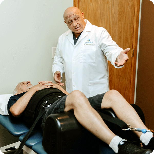 Doctor Tony describes spinal decompression to male patient while in treatment