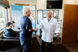 Dr. Tony shaking hands with a patient.