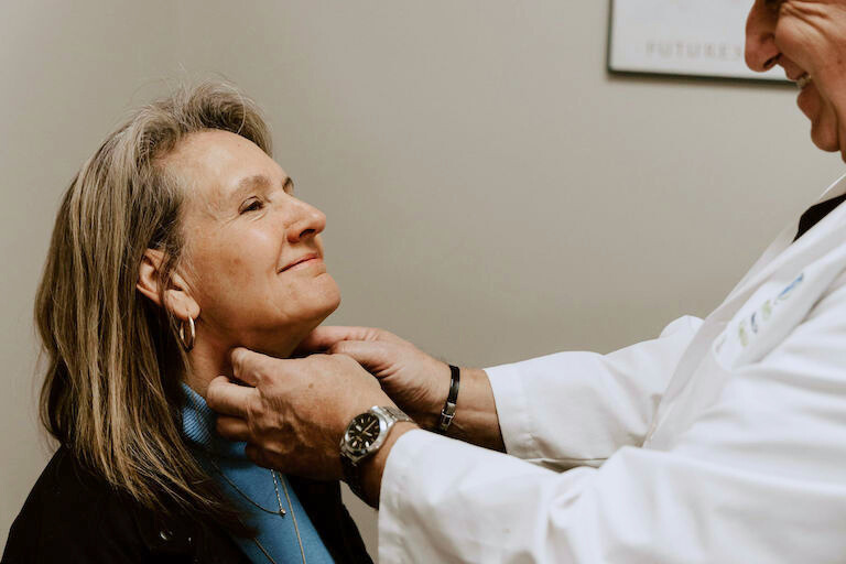 Dr. Tony giving an exam of the lymph nodes in patients neck.